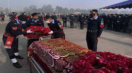 Police officers attend the funeral prayer of a colleague