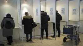 People fill their ballot papers at a poling station in Tallinn