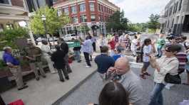 People gather during a dedication ceremony on the Fayetteville square