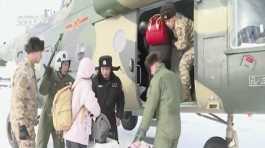Tourists are evacuated by a military helicopter